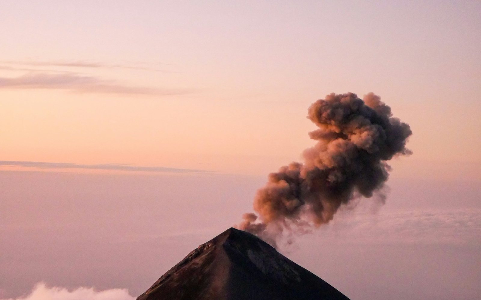 Volcán de Fuego erupting at dawn above Antigua